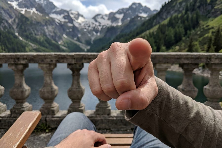 First-person view, finger pointing back at the viewer